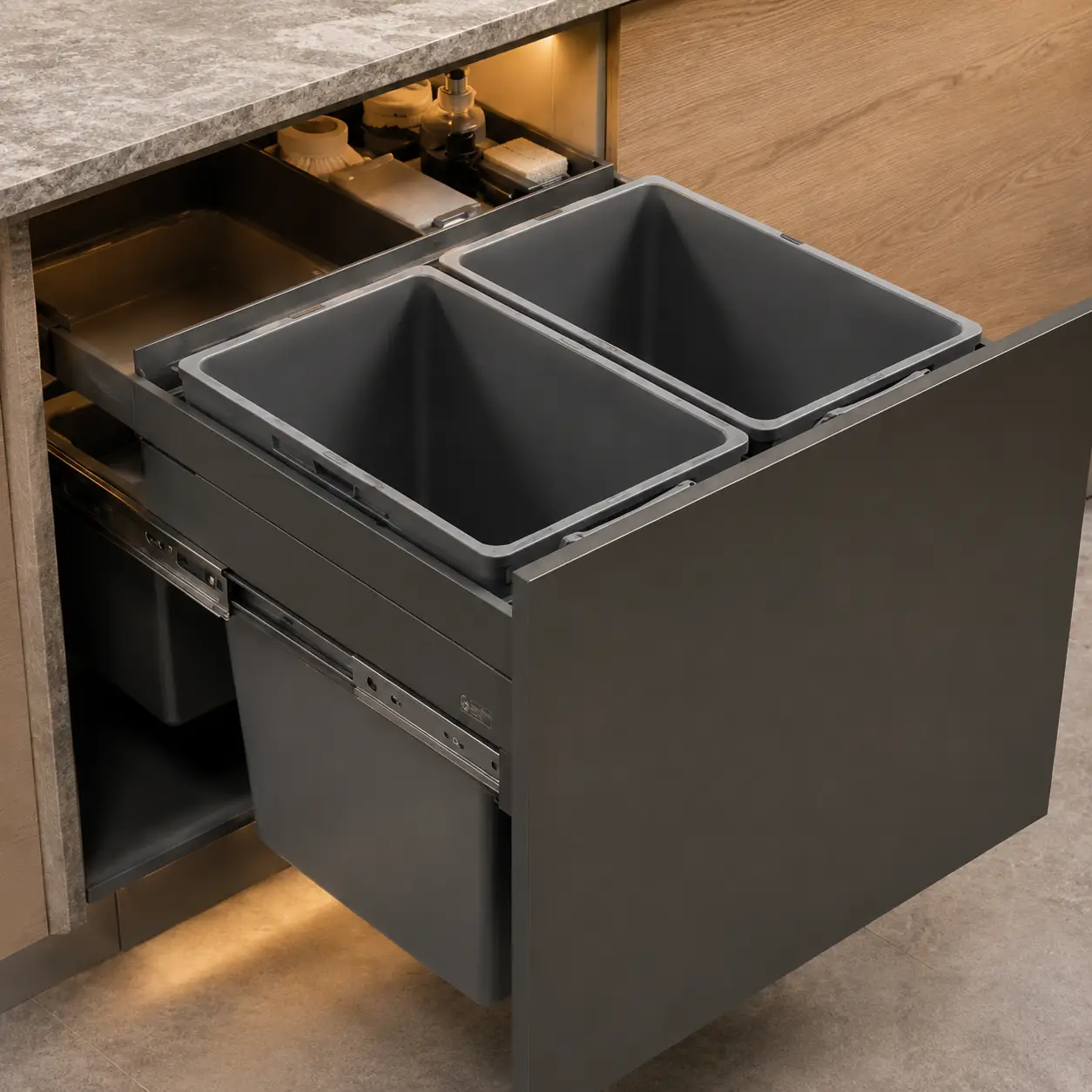 Modular kitchen under-sink wastebin drawer with dedicated storage for cleaning bottles and supplies