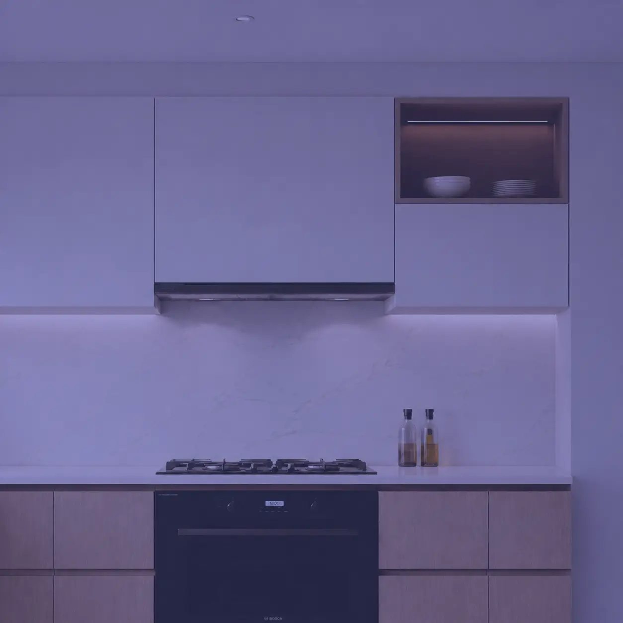 Modern modular kitchen cooking zone with hob, chimney, and organized cooking area